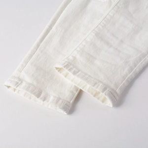 Detailed macro view of white denim hem featuring professional double-stitched seam craftsmanship