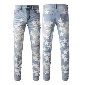 Men's slim fit light blue jeans with white leather star patches and distressed details