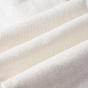 Macro shot of white denim fabric texture showing premium cotton weave and soft finish
