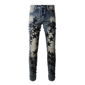 Slim fit men's blue washed jeans featuring black leather star patches and distressed details