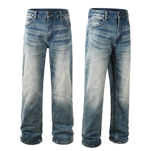 Close-up of straight-leg denim pants showing whiskering effect and washed blue texture