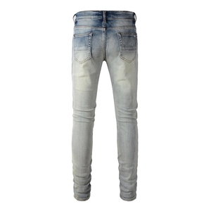 Rear view of light wash slim fit jeans featuring classic five-pocket design and belt loops