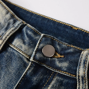 Slim fit washed blue jeans featuring vintage metal button and yellow contrast stitching