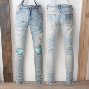 Men's slim fit ripped denim jeans in light blue with unique blue pleated hole lining