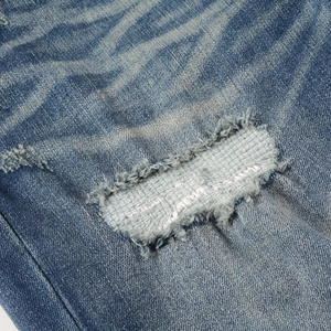 Men's American high street ripped denim jeans with distressed patches and washed texture