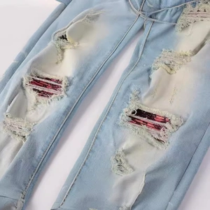 Men's retro slim fit light blue ripped jeans with vintage patchwork and distressed detail