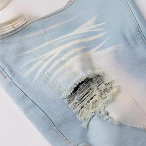 Men's American vintage distressed light blue slim fit denim jeans with ripped details