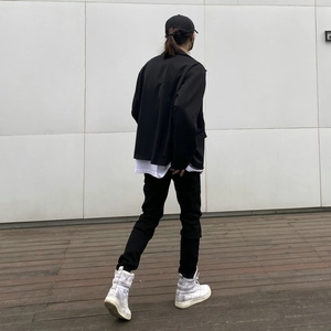 Jean slim noir extensible pour homme porté avec une veste décontractée au style urbain