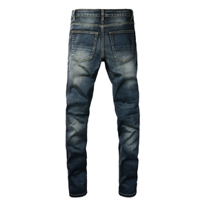 Detail view of the back of men's slim fit jeans with faded wash and back pockets