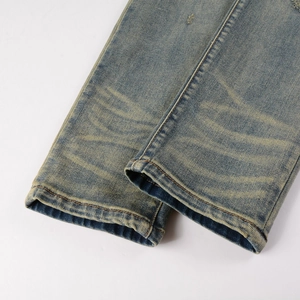 Men's blue distressed denim jeans with vintage wash and rolled cuff stitching detail