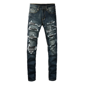 Slim fit men's distressed jeans in dark blue with vintage ripped patches and street style