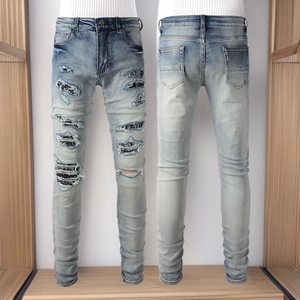 Front and back view of distressed slim fit denim jeans with ripped holes and patches