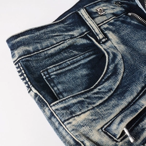 Macro view of biker jeans detailing with washed denim texture and side pleats