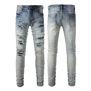 Men's distressed skinny jeans with paisley patches and stacked ankle details