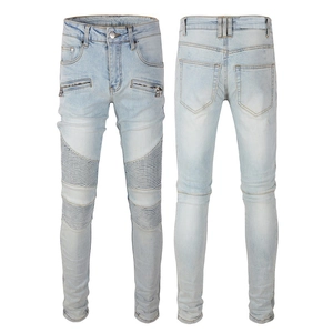 Detail view of biker jeans with accordion pleated knees and decorative zippers