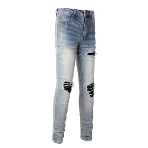 Men's slim fit light blue ripped jeans with striped PU patches on a white background