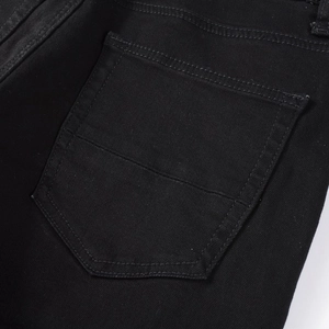 Detailed close-up of the back pocket on these men's black high street slim fit denim jeans