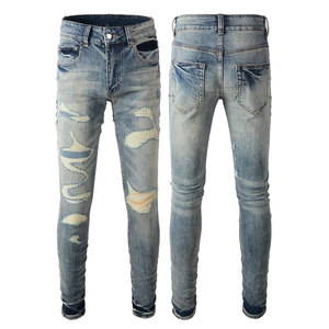 Slim fit light blue distressed jeans for men with ripped patches and washed denim finish