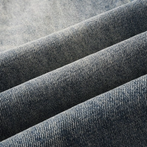Men's loose straight fit blue distressed jeans with vintage washed denim texture