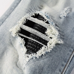 Men's light blue distressed skinny jeans with heavy wash and black quilted lining
