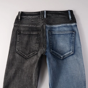 Detail view of biker jeans featuring unique two-tone paneling and accordion pleated waist