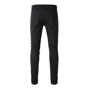 Rear view of slim fit black ripped denim jeans with distressed pocket detailing