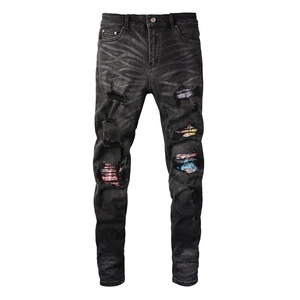Slim fit men's ripped jeans in dark grey with colorful graffiti patch and distressed detail