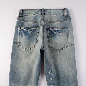 Detailed view of the back pockets and distressed denim texture on vintage blue jeans