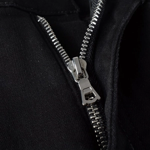Macro shot of silver metal zipper and black twill fabric detail on men's casual jeans