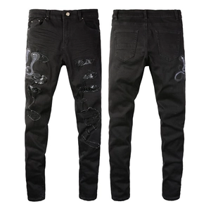 Men's slim black distressed jeans featuring blue snake embroidery and sequin patches