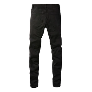 Detailed back view of slim fit black denim jeans with classic symmetric rear pockets