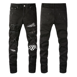 Men's slim fit black distressed jeans with printed patches and worn-out hole details