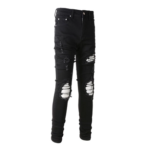 Slim fit black ripped jeans for men featuring distressed knees with white contrast webbing