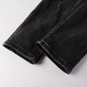 Détails de l'ourlet de jean gris délavé avec couture double et finitions effet vieilli