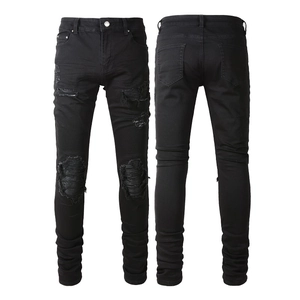 Men's slim fit black distressed jeans with pleated patches and street style heavy ripping