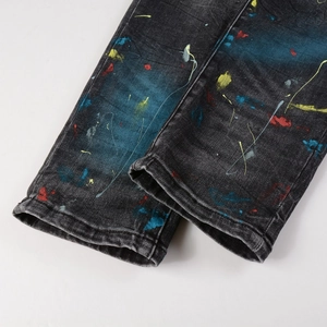 Men's high street distressed jeans with colorful paint splatters and vintage wash
