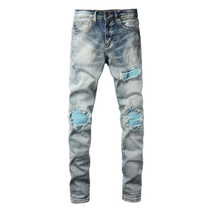 Slim fit men's street jeans in light wash with blue corduroy patches and distressed holes