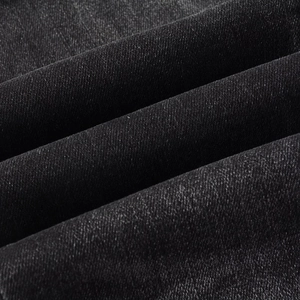 Macro texture of dark grey twill denim fabric with premium cotton blend material