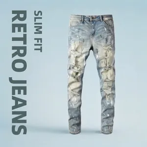Slim fit men's vintage light blue distressed jeans with paint splatters and ripped details
