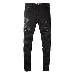 Slim fit black distressed jeans with cobra embroidery and faux crocodile patches