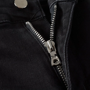 Slim fit black jeans featuring a smooth metal zipper fly and silver button detail