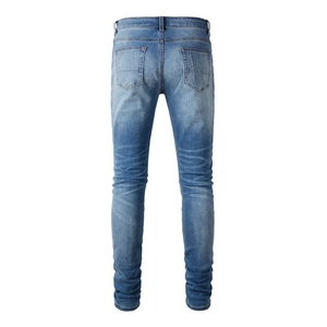 Detailed back view of men's light blue denim jeans with washed effect and rear pockets