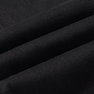 Detailed macro view of black twill denim fabric texture with visible weave patterns