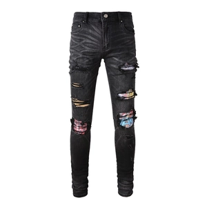 Slim fit men's distressed jeans with graffiti patches and washed black denim finish