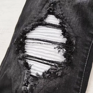 Slim fit men's distressed grey jeans with white striped patches and frayed knee details