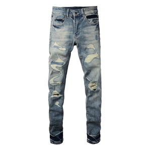 Men's slim fit distressed blue jeans with vintage washed denim and patchwork details