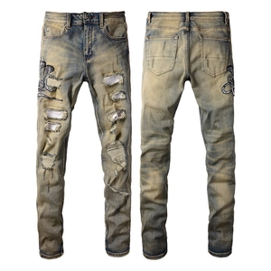 Jean slim rétro jaune pour homme avec broderie serpent et détails déchirés et usés de haute qualité