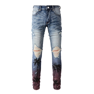 Detail of ripped skinny jeans with palm tree print and purple gradient hem