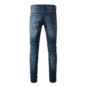 Jean bleu ajusté pour homme avec délavage rétro et texture vintage à moustaches de chat