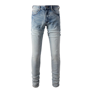 Men's slim fit stretch denim jeans in light blue with distressed cat-whisker wash detail